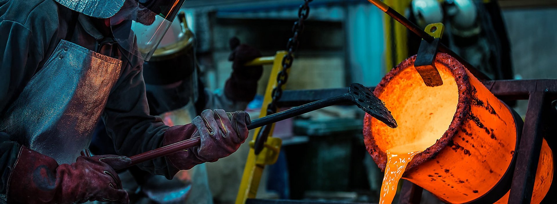 Foundry worker pouring metal in a casting process