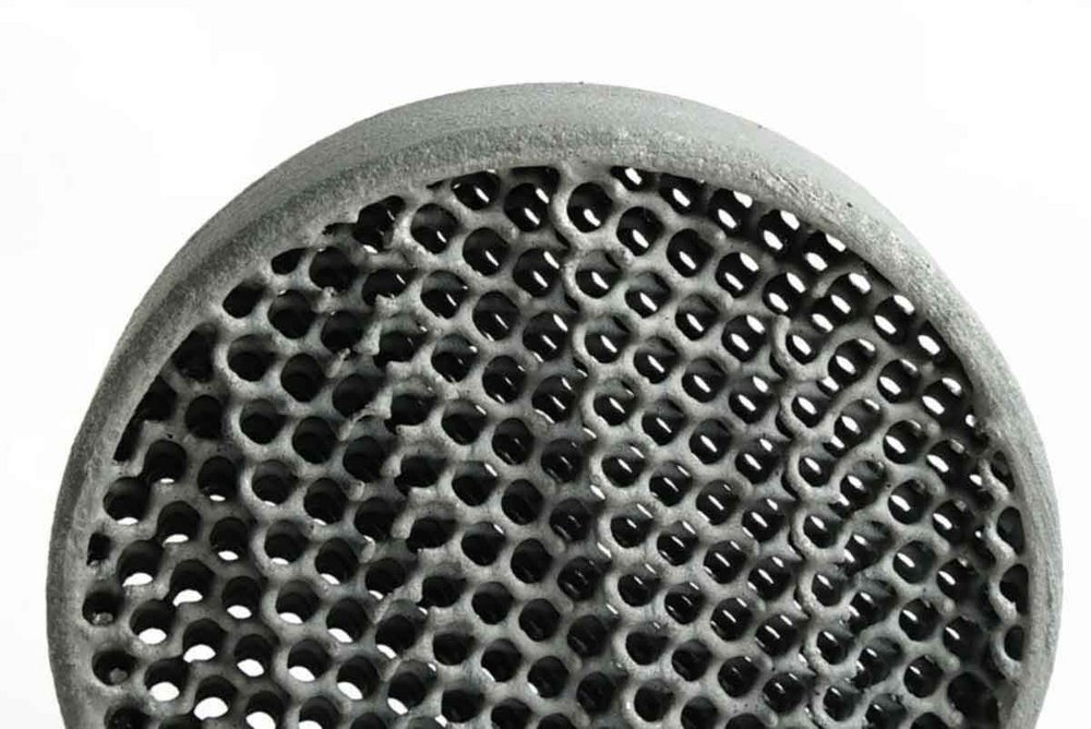 Close-up of a gray ceramic foam filter with a uniform network of interconnected pores