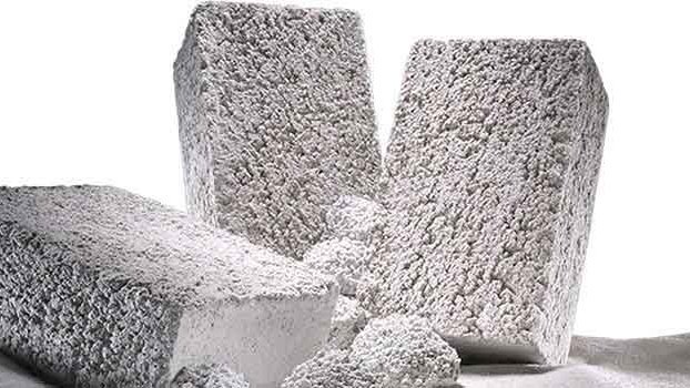 Foseco Melt Shop Refractories Various shapes of Foseco melt shop refractory bricks designed for high temperature applications in metal casting, displayed on a sandy surface
