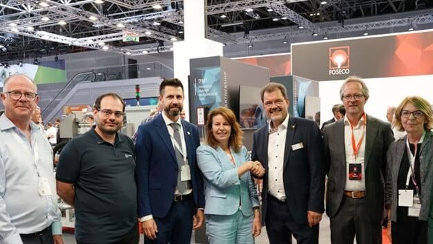 Seven people at GIFA 2023 event, celebrating the Lifetime Legacy sponsorship agreement between Foseco and WFO. Pictured (left to right): Eur. Ing. Andrew Turner (Executive Secretary, WFO), Lionel Alves (Executive Member, WFO), José Javier González (General Secretary, WFO), Karena Cancilleri (President, Foseco), Dr. Carsten Kuhlgatz (President, WFO), Rob Welland (Vice President Marketing & Technology, Foseco), and Lynn Postle (Editor, Foundry Trade Journal), with a Foseco booth in the background.