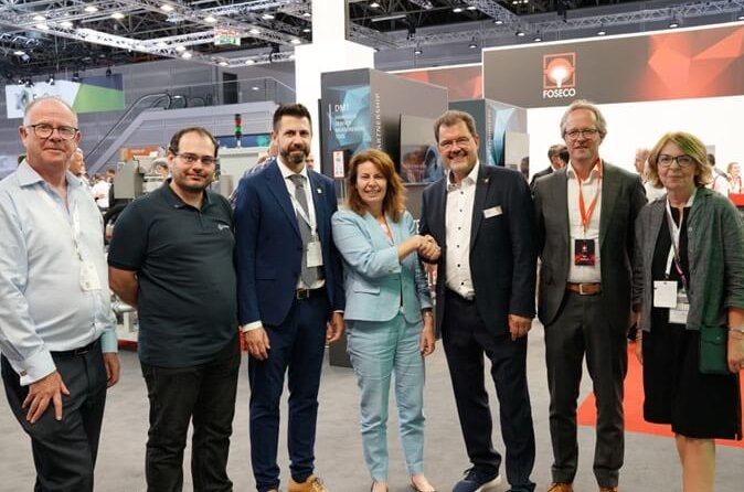 Seven people at GIFA 2023 event, celebrating the Lifetime Legacy sponsorship agreement between Foseco and WFO. Pictured (left to right): Eur. Ing. Andrew Turner (Executive Secretary, WFO), Lionel Alves (Executive Member, WFO), Jos&eacute; Javier Gonz&aacute;lez (General Secretary, WFO), Karena Cancilleri (President, Foseco), Dr. Carsten Kuhlgatz (President, WFO), Rob Welland (Vice President Marketing & Technology, Foseco), and Lynn Postle (Editor, Foundry Trade Journal), with a Foseco booth in the background.