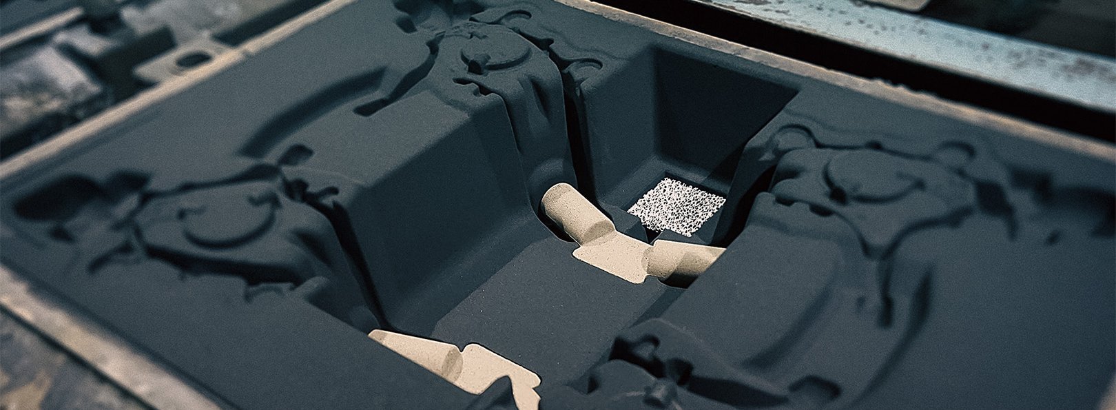 Green sand mould top part on a moulding line showing the mould cavity